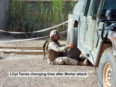 LCpl Torres changing tires after Mortar attack_r